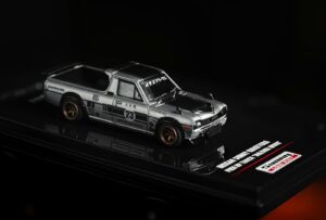 A toy truck is sitting on a card